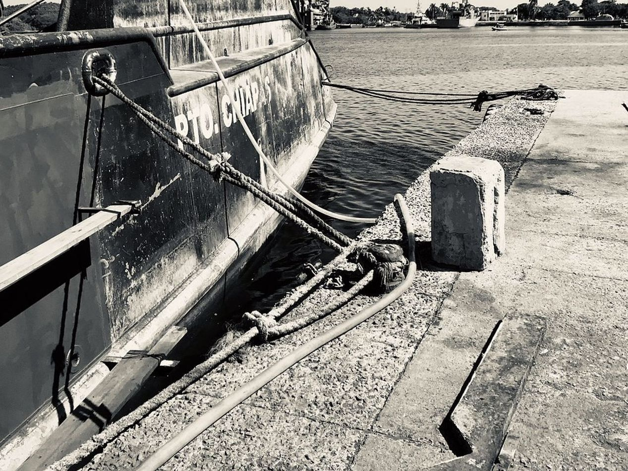 Small fishing boat moored at the dock's edge