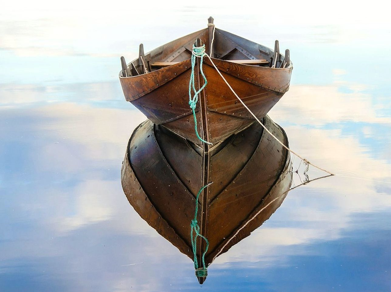 Handcrafted boat pier with rounded timber railings
